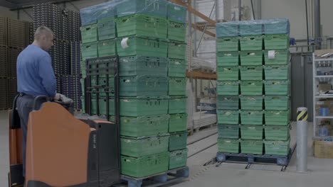 Transporting-crates-in-stockroom-with-forklift