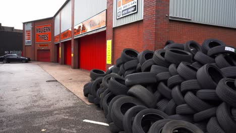 A-large-amount-of-used-rubber-tyres-dumped-outside-a-tyre-fitters-shop