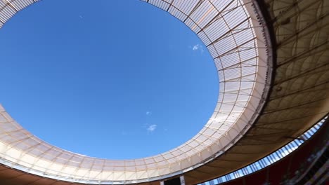 Dramatic-low-angle-shot-panning-across-the-open-roof-of-the-Mane-Garrincha-Stadium
