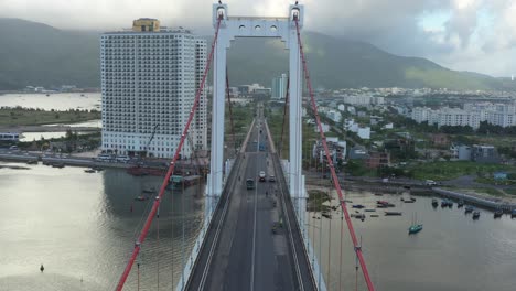Aerial-shot-of-flying-underneath-the-arches-of-a-suspension-bridge-in-Danang,-Vietnam