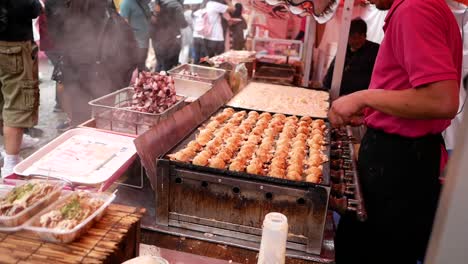 chef-skill-with-chopsticks-when-cook-takoyaki-the-traditional-food-from-japan