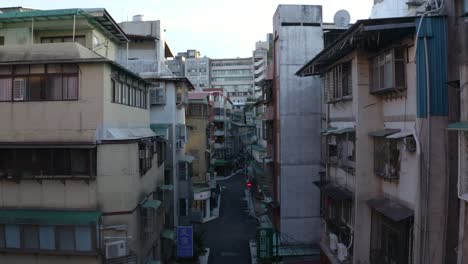 Drone-shot-of-a-street-in-Taipei-city-center,-moving-between-narrow-building