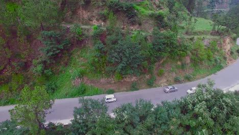 Aerial-view-of-a-curved-winding-roads-trough-the-forest-at-mountain,-Beautiful-nature-and-transportation-from-panoramic-view