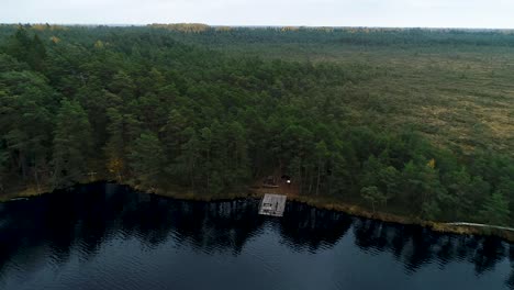 Colorful-seasonal-forests-and-bog-lake-in-autumn-time-aerial-footage