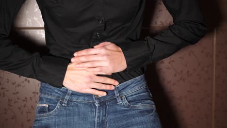 Sudden-abdominal-pain-attack,-bending-with-pain,-hands-on-belly