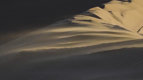 Close-up-of-sand-blowing-in-the-wind-in-slow-motion-on-a-giant-sand-dune-in-the-Little-Sahara-National-Park-in-Juab-Utah