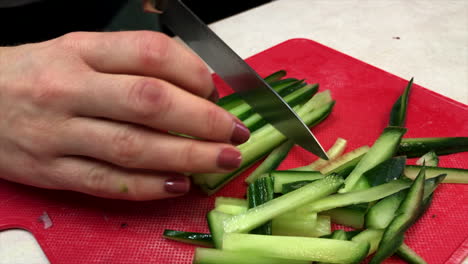 Close-up-of-woman's-hands-julienning-cucumbers