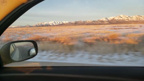 Light-snow-covered-landscape-view-from-moving-car