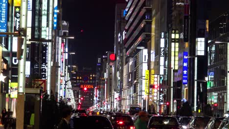The-view-of-the-famous-shopping-street-Ginza-,-cars-and-walking-people-at-night
