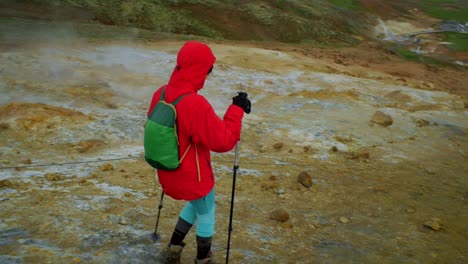 dramatic-iceland-landscape,-person-hiking-on-trail,-krysuvik-seltun-area,-camera-following-movmement,-camera-tracking---dolly-in-on-a-steadicam-gimbal-stabiliser