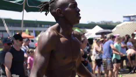 A-black-African-athletic-male-skips-rope-during-a-cross-fit-competition,-skipping-rope,-cardio-vascular-workout-and-popular-with-martial-artists,-boxers-and-cross-fitters
