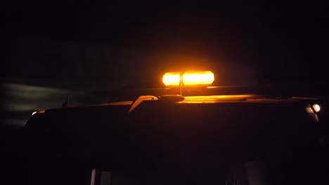 Gelbe-Leuchtfeuer-In-Zeitlupe-Auf-Der-Oberseite-Eines-Straßenbau-Sicherheitswagens-In-Großbritannien-Bei-Nacht