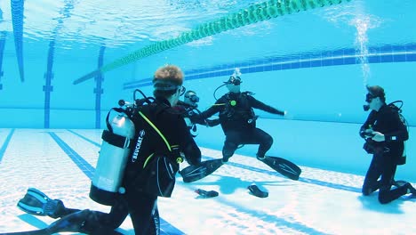 A-group-of-scuba-diving-students-learning-safety-procedures-in-a-swimming-pool