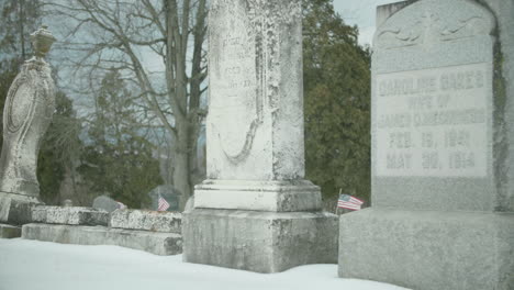 Old-Worn-Tombstones-in-Snow-Covered-Cemetery-TILT-UP