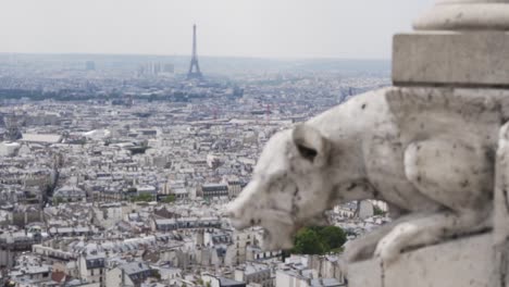 SLOW-MOTION:-rack-focus-from-sculpture-to-city-view-with-Eiffel-Tower,-Paris