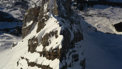 Aerial-view-flying-along-a-rocky-and-snowy-mountain-ridge-in-the-French-Alps-near-La-Clusaz-in-winter