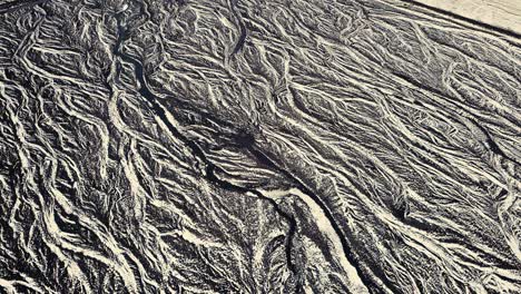 Drone-showing-beautiful-patterns-in-the-landscape-below,-on-snowy-conditions