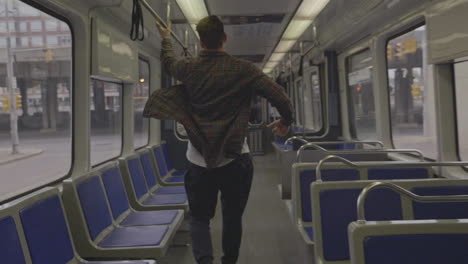 Caucasian-man-running-in-slow-motion-inside-a-subway-car