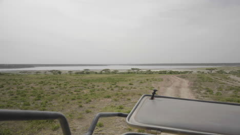 View-of-a-lake-from-a-safaris-tour-car-in-Serengeti-Valley,-Serengeti-National-Park,-Tanzania