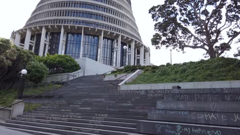 Tilt-up-revealing-steps-to-parliament-building,-no-people