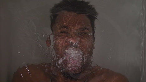 Angry-African-American-man-screaming-under-water-in-a-bath-tub