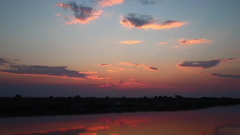 A-boat-cruise-along-the-Namibia-side-of-the-Zambezi-river-in-summer-in-the-Caprivi-Strip-Zambezi-Region-at-sunset
