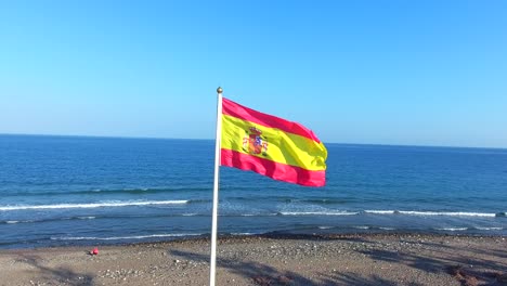 spanish-flag-on-the-beach-filmed-in-marbella,-Spain
