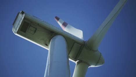 Afternoon-lower-perspective-and-standing-footage-from-a-wind-turbine-machine's-rotating-blades