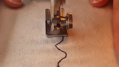 Sewing-machine-with-fabric-and-thread,-closeup