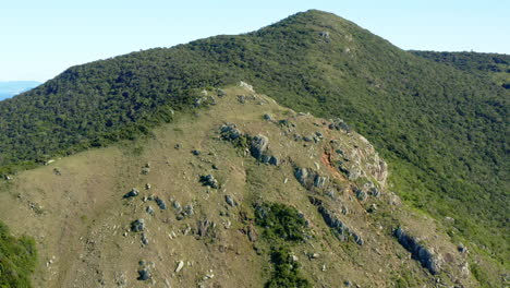 Morro-Da-Coroa-summit-establishing-aerial-shot-at-Lagoinha-Do-Leste-beach,-Florianopolis,-Santa-Catarina,-Brazil