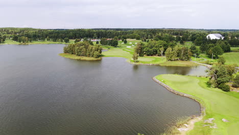 Aerial-birds-eye-view-of-golf-course-in-Stockholm-by-the-lake