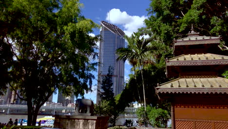 Brisbane-River-with-City-Cat-Ferry-and-buildings-in-background-from-The-Nepalese-Pagoda,-South-Bank,-Australia