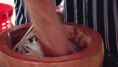 Using-a-Pestle-and-Mortar-to-Mix-Ingredients-fro-Street-Food
