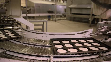 Time-lapse-of-trays-of-dough-transferred-automatically-inside-bread-factory