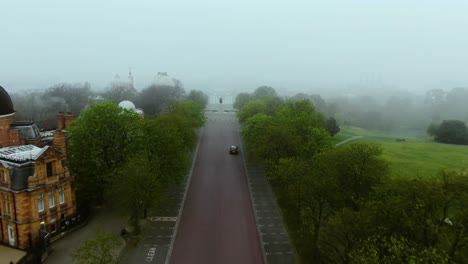 Beautiful-Foggy-aerial-view-of-the-asphalt-road-and-tree's-beside