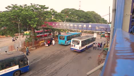 Aerial-View-of-urban-Public-bus-station,-Buses-moving-out-from-the-bus-station-in-the-majestic-bus-station-Bengaluru,-India