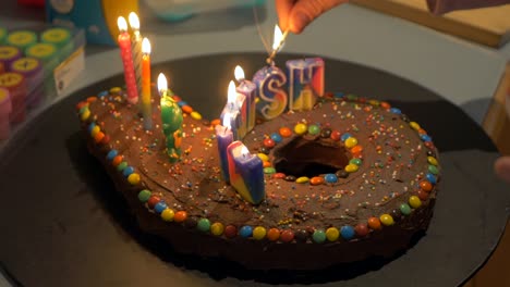 Child's-Birthday-Cake-Lit-With-Candles