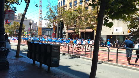 Falun-Dafa,-also-known-as-Falun-Gong,-practitioners-during-march-band-through-streets-of-downtown-in-San-Francisco-protesting-against-religious-persecution-from-chinese-communist-party-of-Jiang-Zemin