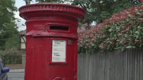 A-left-aligned-close-up-shot-of-a-Red-Royal-Mail-Post-box-on-a-residential-street-in-South-West-London