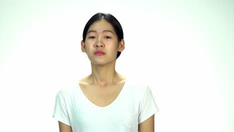 Young-Asian-20s-Woman-black-wrapped-hair-without-cosmetic-make-up-or-fresh-face-look-in-t-shirt-express-emotion-angry-on-white-background-for-viral-clip-Casting-or-advertising