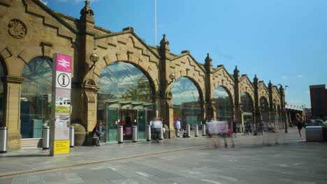 Timelapse-of-Sheffield-Train-Station-Entrance-with-People-walking-in-and-out-from-the-Station-and-clouds-passing-by-Sunny-Day-4K-25p
