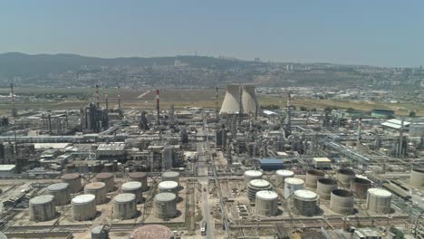 Aerial-footage-of-a-large-scale-Oil-refinery-with-smoke-stacks-and-petroleum-storage-tanks