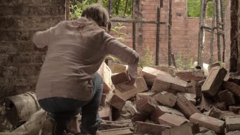 Woman-moving-rubble-and-debris-after-disaster