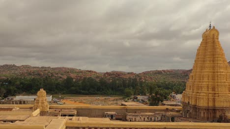 Pan-view-of-Virupaksha-temple-gopuram-from-top-of-the-HemaKuta-hill-at-Hampi,-India