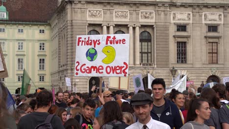 Fridays-for-future-signs-being-held-up-at-hero-square-during-climate-change-protests-in-Vienna,-Austria