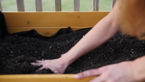 hands-moving-dirt-and-fertilizer