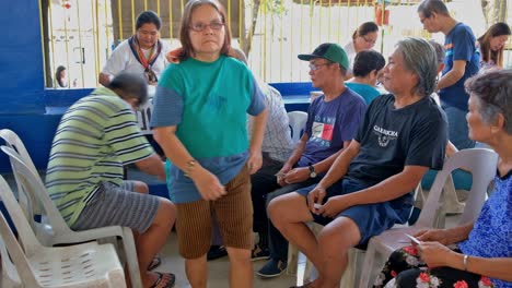Enrolled-senior-citizens-line-up-to-receive-their-monthly-cash-allowance-in-Cebu-City,-Philippines