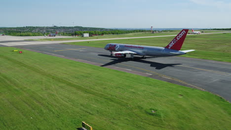 Aerial-footage-of-a-Jet2-aircraft-arriving-and-taxiing-onto-its-arrivals-gate
