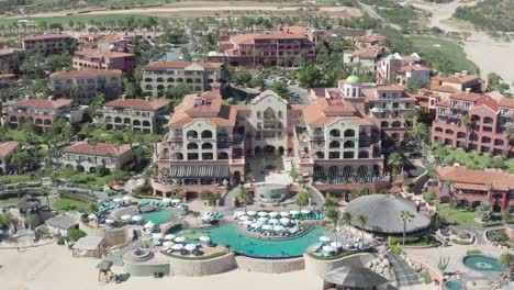 Luxury-Sheraton-Grand-Los-Cabos-Hacienda-Del-Mar-Hotel-on-Coast-of-Baja-California,-Mexico,-Pull-Back-Aerial