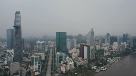 high-aerial-view-of-Saigon-River-waterfront-areas-and-financial-district-of-Ho-Chi-Minh-City,-Vietnam